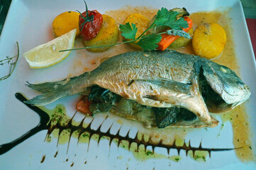 Fish dish Dorada (Sparus aurata) with various vegetables