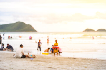 Blur image of group activity holiday and vacation on the beach with beautiful light, used as background image.