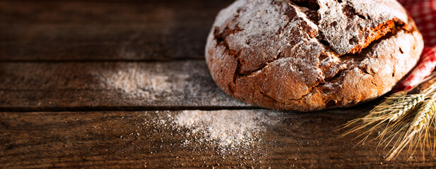 Fresh baked bread on rustic wood
Fresh crispy bread and flour on rustic wood. Horizontal background...