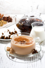 cup of masala tea and Christmas cookies on white background, vertical