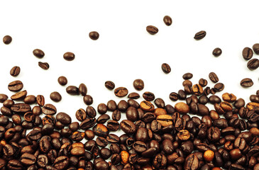 coffee beans scattered on a white background. aromatic arabica on a background with copy space. mockup