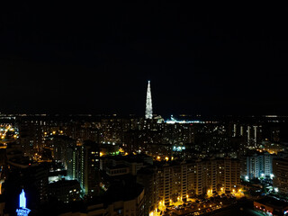 Fototapeta na wymiar Drone overlooking the city at night, lit streets and dark sky