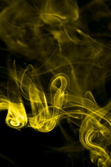 Yellow smoke on black background