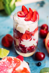 Dessert with raspberry, strawberry, ice cream in glass