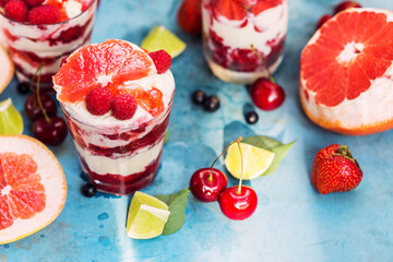 Desserts with raspberry, ice cream and grapefruit on blue table