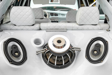 Tuned car with powerful audio system and sub woofers in the car trunk. Custom white car interior.