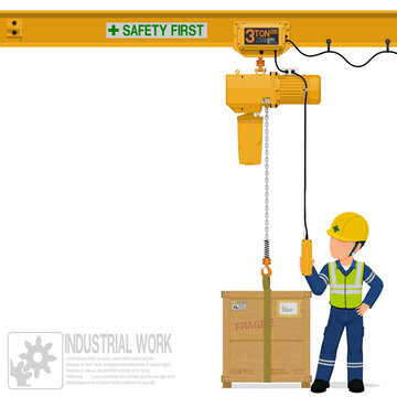 An industrial worker is operating electric chain hoist