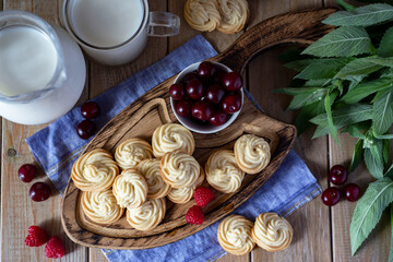 Vanilla cookies on a beautiful Board with berries and mint. The view from the top.