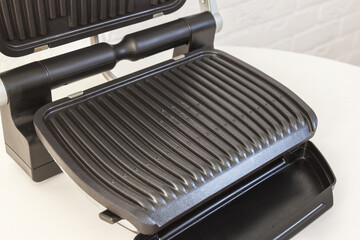 Ridge teflon surface of an electric grill. Close-up view of barbecue for home use. - 368845127