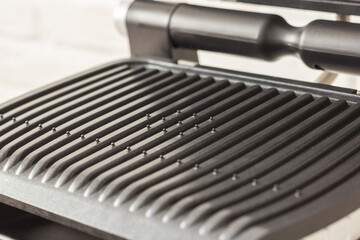 Ridge teflon surface of an electric grill. Close-up view of barbecue for home use. - 368845175