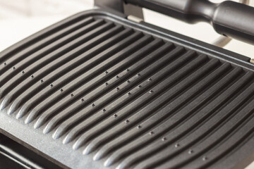 Ridge teflon surface of an electric grill. Close-up view of barbecue for home use. - 368845182