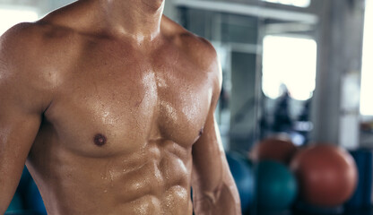 Close up chest of muscular topless man sweating after workout exercise at fitness. athletic people abs and biceps. sexy body from bodybuilding of healthy sporty male. copy space 