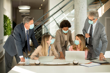 Group of business people have a meeting and working in office and wear masks as protection from corona virus