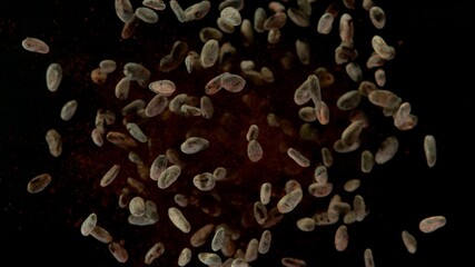 Aromatic cocoa beans flying up in the air