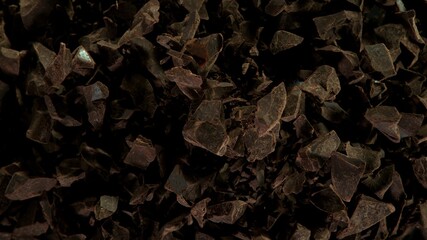 Freeze motion of flying group of raw chocolate pieces.