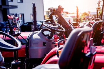Fototapeta premium Rows of modern tractors. Industrial details. Agricultural 