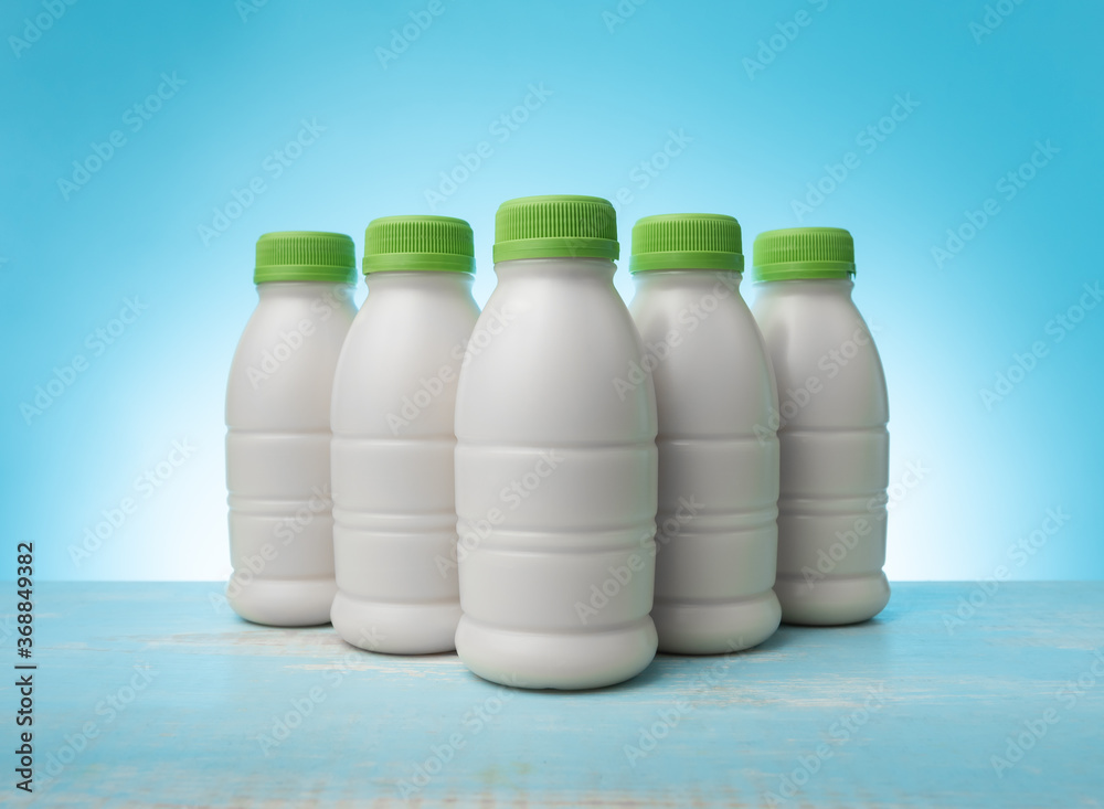 Sticker bottle of milk on blue color background.