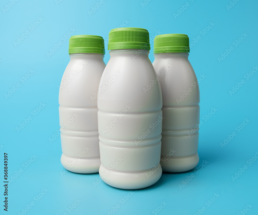 Sticker bottle of milk on blue color background.