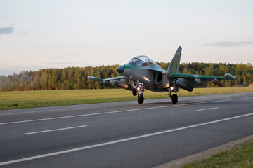 Fototapeta na wymiar Yak-130 (NATO classification: Mitten) takes off from the airfield.