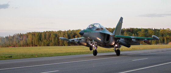 Fototapeta na wymiar Yak-130 (NATO classification: Mitten) takes off from the airfield.