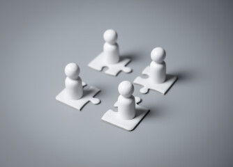 Wooden people standing on puzzles ,human resources and management concept,teamwork