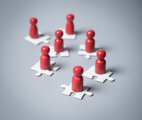 Obraz premium Wooden people standing on puzzles ,human resources and management concept,teamwork