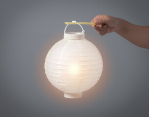 Hand holding white paper lantern traditional japanese