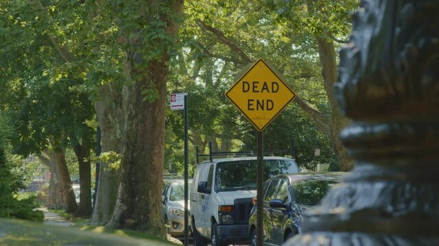 Dead End Street Sign Surrounded by Green Leafy Trees On Suburban Street During The Daytime in Brooklyn, New York
