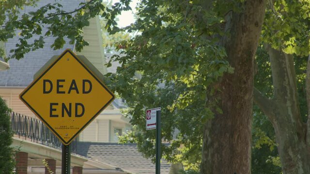 Dead End Street Sign Surrounded by Green Leafy Trees In A Suburban Neighborhood During The Daytime in Brooklyn, New York