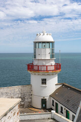 Old lighthouse on the coast of Ireland. County Wicklow.