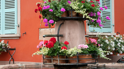 Old fountain decorated with colorful flowers
