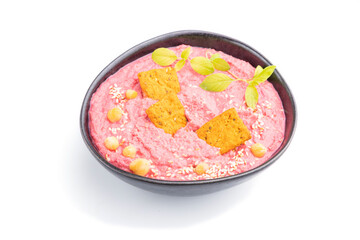 Hummus with beet and microgreen basil sprouts in ceramic bowl isolated on white background. Side view.