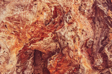 Red stone cave wall as background or backdrop.