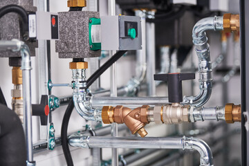 Pump, controller and steel pipeline in boiler room © Kadmy