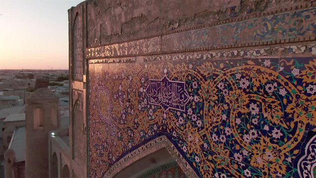 Portal of mosque in old Bukhara, Uzbekistan in the rays of the setting sun, drone aerial