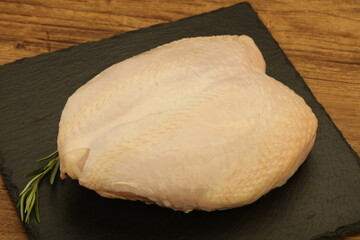 Raw whole chicken breast with skin