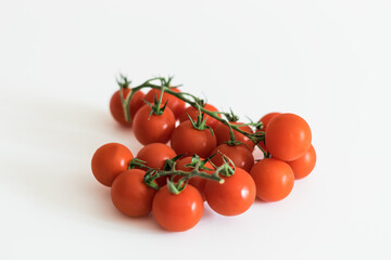 fresh red tomatoes on a green branch
