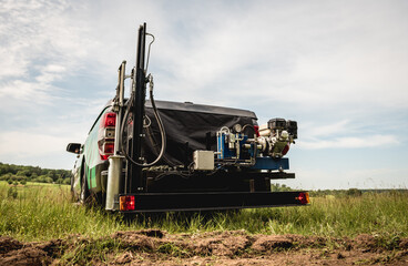Fototapeta premium Soil examination. Collecting black soil on the field for examination