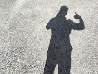 Silhouette of a man on the asphalt