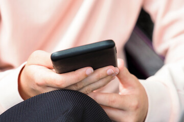 City lifestyle, woman on phone. Text message on smartphone app, sitting outdoor