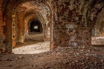 Brick corridor on the lower level in an old abandoned and decaying building