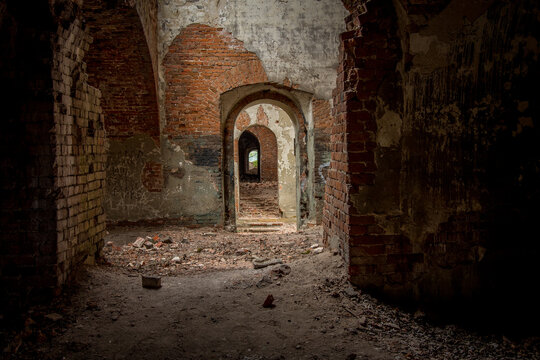 Brick corridor on the lower level in an old abandoned and decaying building