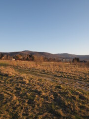 Obraz na płótnie Canvas Silesian Beskid Mountains range seen from sport airfield in european Bielsko-Biala city in Poland, clear blue sky in 2020 warm sunny spring day on April at sun set - vertical.