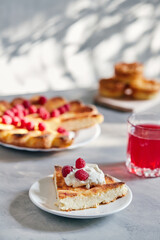 Delicious curd muffin with raspberries on a light background.