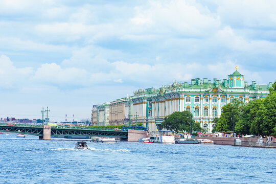 Palace bridge, Hermitage, Palace pier, tourists and vacationers on the city street. Summer view of the downtown of Saint Petersburg from the Neva river