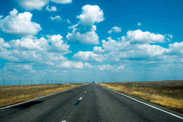 Photo of a good road going into the distance. Summer track with markings.