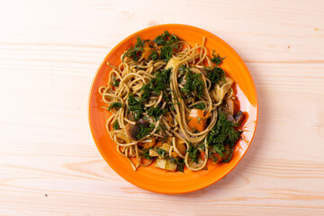 spaghetti on orange plate