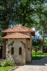 Fototapeta na wymiar Old Mediterranean stone house in green garden. Mediterranean style decoration of a garden 