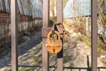 old rusty lock on a metal gate