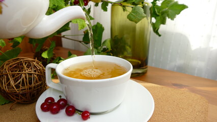 tea flows from the kettle to the cup